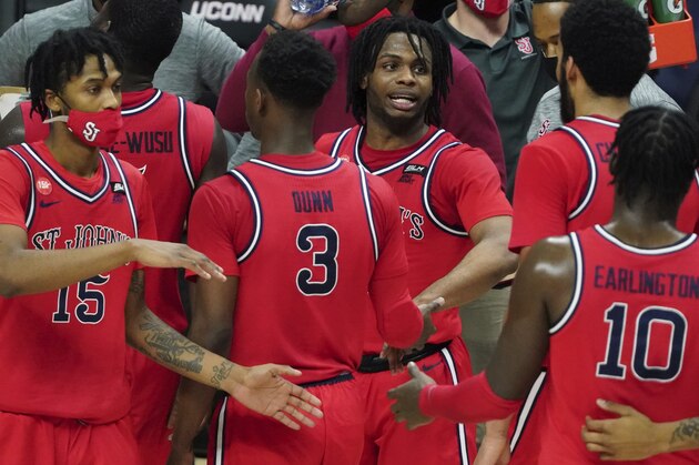 St. John's guard Posh Alexander, center, and teammates react during a break in the action against Connecticut in the second half of an NCAA college basketball game in Storrs, Conn., Monday, Jan. 18, 2021.  (David Butler II/Pool Photo via AP)