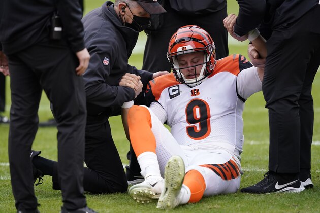 Cincinnati Bengals quarterback Joe Burrow (9) is helped getting off the field during the second half of an NFL football game against the Washington Football Team, Sunday, Nov. 22, 2020, in Landover, Md. Bengals rookie suffered a left knee injury during this play and was carted off the field. (AP Photo/Susan Walsh) Cincinnati Bengals quarterback Joe Burrow (9) is helped getting off the field during the second half of an NFL football game against the Washington Football Team, Sunday, Nov. 22, 2020, in Landover, Md. Bengals rookie suffered a left knee injury during this play and was carted off the field. (AP Photo/Susan Walsh)