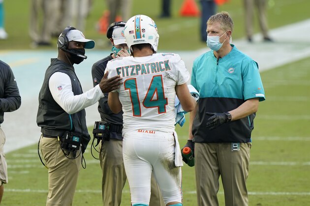Miami Dolphins quarterback Ryan Fitzpatrick (14) talks to head coach Brian Flores during the first half of an NFL football game against the New York Jets, Sunday, Oct. 18, 2020, in Miami Gardens, Fla. (AP Photo/Wilfredo Lee) Miami Dolphins quarterback Ryan Fitzpatrick (14) talks to head coach Brian Flores during the first half of an NFL football game against the New York Jets, Sunday, Oct. 18, 2020, in Miami Gardens, Fla. (AP Photo/Wilfredo Lee)