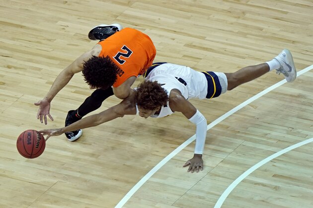 Oklahoma State's Cade Cunningham (2) and West Virginia's Miles McBride chase a loose ball during the first half of an NCAA college basketball game in the second round of the Big 12 Conference tournament in Kansas City, Mo., Thursday, March 11, 2021. (AP Photo/Charlie Riedel)