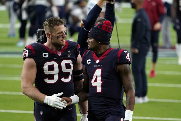 Houston Texans defensive end J.J. Watt (99) and quarterback Deshaun Watson (4) walk off the field after an NFL football game against the Tennessee Titans Sunday, Jan. 3, 2021, in Houston. The Titans won 41-38. (AP Photo/Eric Christian Smith)