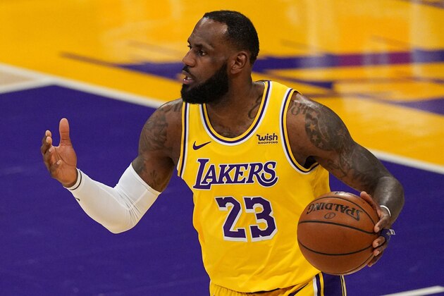 Los Angeles Lakers forward LeBron James dribbles during the first half of an NBA basketball game against the Miami Heat Saturday, Feb. 20, 2021, in Los Angeles. (AP Photo/Mark J. Terrill)