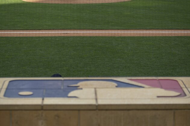 Minnesota Twins' Jose Berrios throws in an intrasquad game in an empty Target Field with the MLB logo on the dugout at a baseball camp Monday, July 13, 2020, in Minneapolis. (AP Photo/Bruce Kluckhohn)