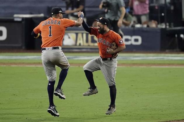 Houston Astros Carlos Correa (1) celebrates with Jose Altuve after winning Game 6 of a baseball American League Championship Series, Friday, Oct. 16, 2020, in San Diego. The Astros defeated the Rays 7-4 to tie the series 3-3. (AP Photo/Jae C. Hong)