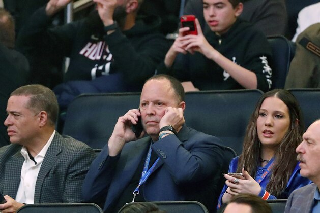Former player agent and new New York Knicks president Leon Rose, center, takes a phone call during the first quarter of an NBA basketball game against the Houston Rockets in New York, Monday, March 2, 2020. (AP Photo/Kathy Willens)