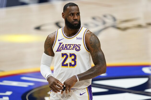 Los Angeles Lakers forward LeBron James takes the court before the team's NBA basketball game against the Denver Nuggets on Sunday, Feb. 14, 2021, in Denver. (AP Photo/David Zalubowski)
