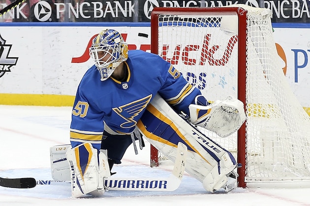 The puck slips past St. Louis Blues' goaltender Jordan Binnington (50) for a San Jose Sharks goal during the third period of an NHL hockey game Saturday Feb. 20, 2021, in St. Louis. (AP Photo/Scott Kane)