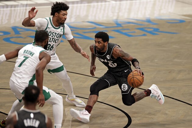 Brooklyn Nets guard Kyrie Irving drives to the basket past Boston Celtics guard Marcus Smart (36) during the first half of an NBA basketball game, Thursday, March 11, 2021, in New York. (AP Photo/Adam Hunger)