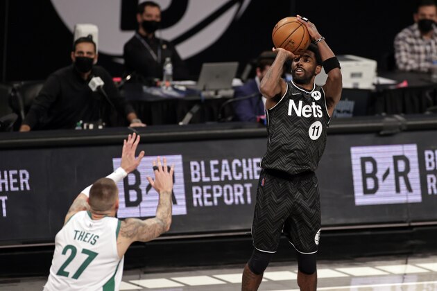 Brooklyn Nets guard Kyrie Irving (11) shoots over Boston Celtics center Daniel Theis (27) during the second half of an NBA basketball game, Thursday, March 11, 2021, in New York. (AP Photo/Adam Hunger)