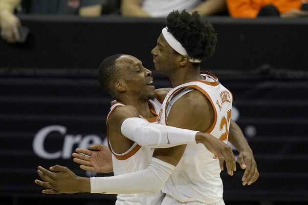Texas guard Matt Coleman III, left, celebrates with forward Kai Jones (22) following an NCAA college basketball game against Texas Tech in the quarterfinal round of the Big 12 men's tournament in Kansas City, Mo., Thursday, March 11, 2021. Texas defeated Texas Tech 67-66. (AP Photo/Orlin Wagner)