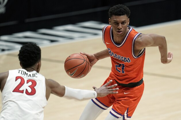 Boise State guard Derrick Alston Jr. (21) controls the ball against San Diego State forward Joshua Tomaic (23) during the second half of an NCAA college basketball game Saturday, Feb 27, 2021, in San Diego. (AP Photo/Gregory Bull)