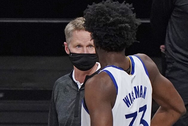 Golden State Warriors head coach Steve Kerr, left, speaks to center James Wiseman (33) before the start of an opening night NBA basketball game against the Brooklyn Nets, Tuesday, Dec. 22, 2020, in New York. (AP Photo/Kathy Willens)