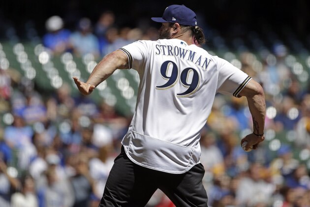 Professional wrestler Braun Strowman throws out the first pitch before a baseball game between the Milwaukee Brewers and the Los Angeles Dodgers Sunday, April 21, 2019, in Milwaukee. (AP Photo/Aaron Gash)
