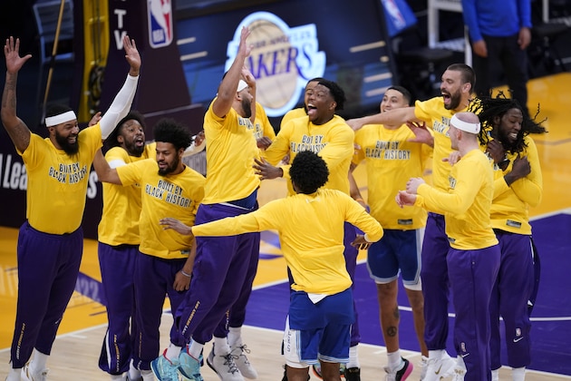 The Los Angeles Lakers interact after player introductions before the start of an NBA basketball game against the Brooklyn Nets Thursday, Feb. 18, 2021, in Los Angeles. (AP Photo/Marcio Jose Sanchez)