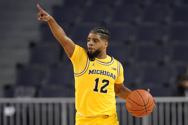 Michigan Wolverines guard Mike Smith (12) signals a play against Rutgers in the second half of an NCAA college basketball game in Ann Arbor, Mich., Thursday, Feb. 18, 2021. (AP Photo/Paul Sancya)