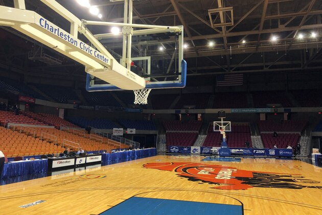 FILE - In this March 12, 2020, file photo, the  Charleston Civic Center arena sits empty after the West Virginia girls state basketball tournament in Charleston, W.Va., was suspended due to concerns over the coronavirus. The West Virginia Secondary School Activities Commission announced Tuesday, April 21, 2020, that it had canceled the boys and boys state basketball tournaments as well as the spring sports of tennis, track, softball and baseball.  (AP Photo/John Raby, File)