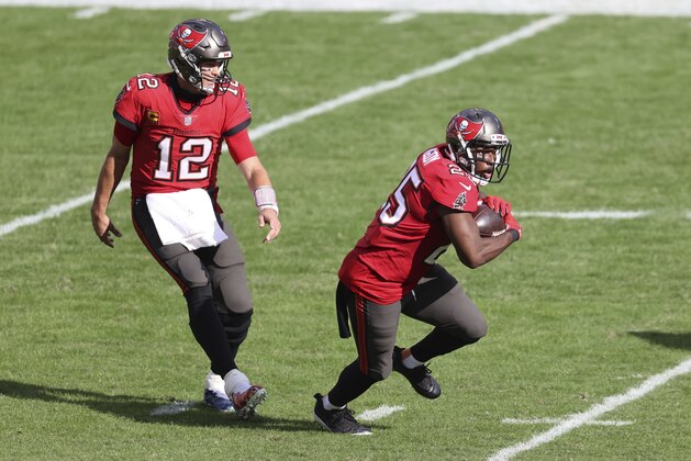 Tampa Bay Buccaneers quarterback Tom Brady (12) hands off to running back LeSean McCoy (25) during the second half of an NFL football game against the Minnesota Vikings Sunday, Dec. 13, 2020, in Tampa, Fla. (AP Photo/Mark LoMoglio)