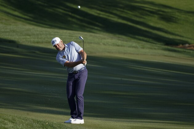 Lee Westwood, of England, chips to the green on the ninth hole during the second round of the The Players Championship golf tournament Friday, March 12, 2021, in Ponte Vedra Beach, Fla. (AP Photo/Gerald Herbert)
