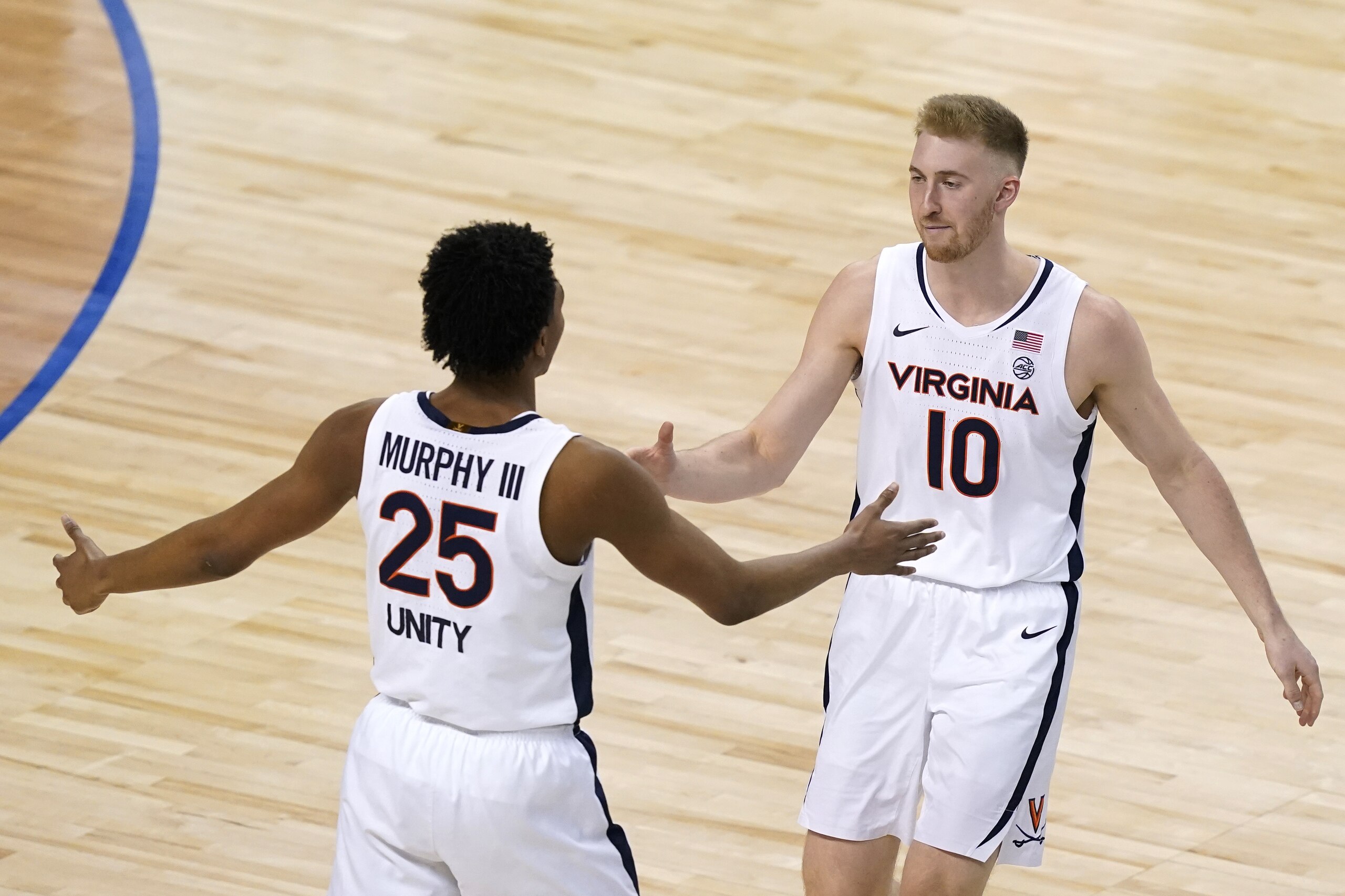 Virginia forward Sam Hauser (10) and Virginia guard Trey Murphy III (25) celebrate a basket during the second half of an NCAA college basketball game in the quarterfinal round of the Atlantic Coast Conference tournament in Greensboro, N.C., Thursday, March 11, 2021. (AP Photo/Gerry Broome)