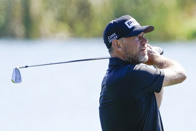 Lee Westwood, of England, hits a shot from the 18th fairway during a practice round at the The Players Championship golf tournament Wednesday, March 10, 2021, in Ponte Vedra Beach, Fla. (AP Photo/John Raoux)