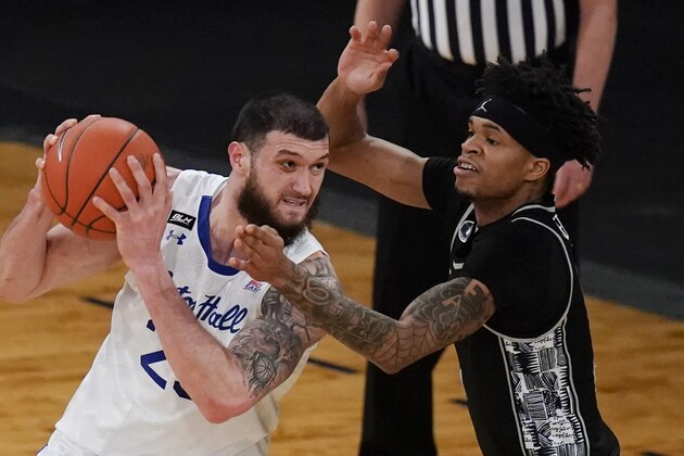 Georgetown's Jamorko Pickett, right, defends against Seton Hall's Sandro Mamukelashvili during the first half of an NCAA college basketball game in the semifinals in the Big East men's tournament Friday, March 12, 2021, in New York. (AP Photo/Frank Franklin II)