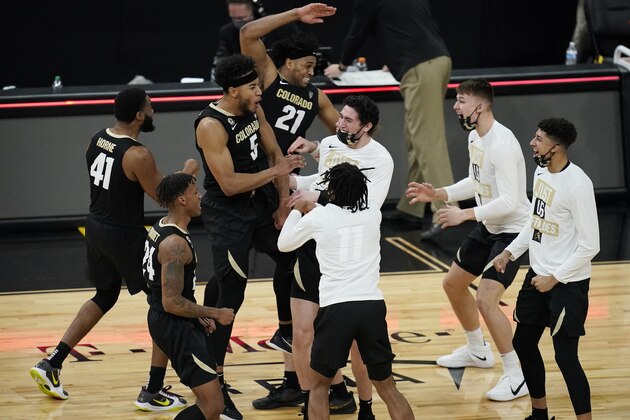 Colorado players celebrate after defeating Southern California in an NCAA college basketball game in the semifinal round of the Pac-12 men's tournament Friday, March 12, 2021, in Las Vegas. (AP Photo/John Locher)