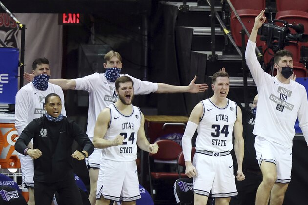 The Utah State bench reacts during the second half of an NCAA college basketball game against Colorado State in the semifinal round of the Mountain West Conference men's tournament Friday, March 12, 2021, in Las Vegas. (AP Photo/Isaac Brekken)