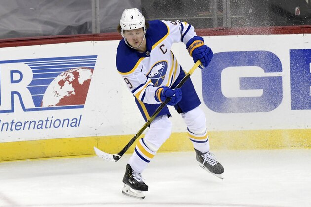 Buffalo Sabres center Jack Eichel (9) passes the puck during the third period of an NHL hockey game against the New Jersey Devils Tuesday, Feb. 23, 2021, in Newark, N.J. (AP Photo/Bill Kostroun)
