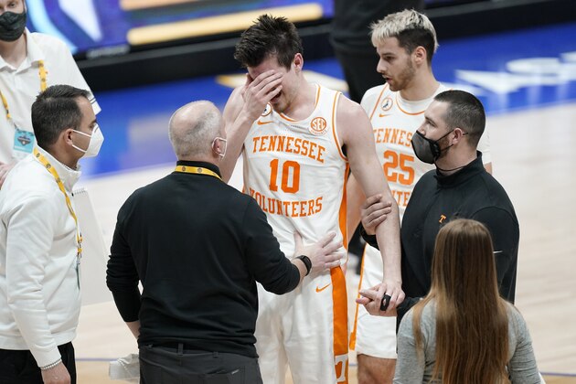 Tennessee's John Fulkerson (10) is helped up after being fouled by Florida's Omar Payne in the second half of an NCAA college basketball game in the Southeastern Conference Tournament Friday, March 12, 2021, in Nashville, Tenn. (AP Photo/Mark Humphrey)