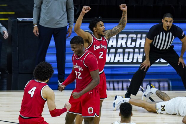 Ohio State's Duane Washington Jr. (4), E.J. Liddell (32) and Musa Jallow (2) celebrate after a 68-67 win over Michigan in an NCAA college basketball game at the Big Ten Conference tournament in Indianapolis, Saturday, March 13, 2021. (AP Photo/Michael Conroy)