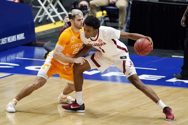 Tennessee's Santiago Vescovi (25) defends against Alabama's Herbert Jones (1) in the second half of an NCAA college basketball game in the Southeastern Conference Tournament Saturday, March 13, 2021, in Nashville, Tenn. (AP Photo/Mark Humphrey)