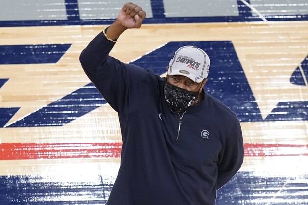Georgetown head coach Patrick Ewing gestures towards fans while standing next to the tournament trophy after an NCAA college basketball game in the championship of the Big East Conference tournament Saturday, March 13, 2021, in New York. (AP Photo/Frank Franklin II) Georgetown head coach Patrick Ewing gestures towards fans while standing next to the tournament trophy after an NCAA college basketball game in the championship of the Big East Conference tournament Saturday, March 13, 2021, in New York. (AP Photo/Frank Franklin II)