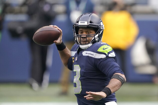 Seattle Seahawks quarterback Russell Wilson readies a pass against the Los Angeles Rams during the first half of an NFL wild-card playoff football game, Saturday, Jan. 9, 2021, in Seattle. (AP Photo/Ted S. Warren)