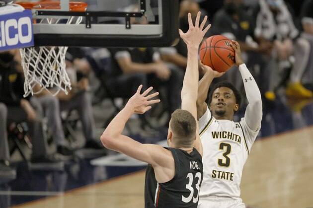 Wichita State guard Alterique Gilbert (3) shoots over Cincinnati center Chris Vogt (33) during the first half of an NCAA college basketball game in the semifinal round of the American Athletic Conference men's tournament Saturday, March 13, 2021, in Fort Worth, Texas. (AP Photo/Ron Jenkins)