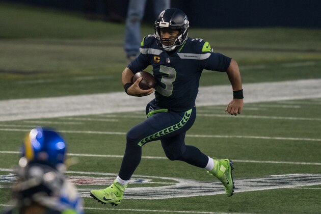 Seattle Seahawks quarterback Russell Wilson runs with the ball during the second half of an NFL wild-card playoff football game against the Los Angeles Rams, Saturday, Jan. 9, 2021, in Seattle. The Rams won 30-20. (AP Photo/Stephen Brashear) Seattle Seahawks quarterback Russell Wilson runs with the ball during the second half of an NFL wild-card playoff football game against the Los Angeles Rams, Saturday, Jan. 9, 2021, in Seattle. The Rams won 30-20. (AP Photo/Stephen Brashear)
