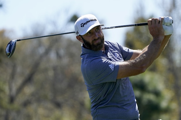 Dustin Johnson watches his tee shot on the ninth hole during the second round of the The Players Championship golf tournament Friday, March 12, 2021, in Ponte Vedra Beach, Fla. (AP Photo/John Raoux)
