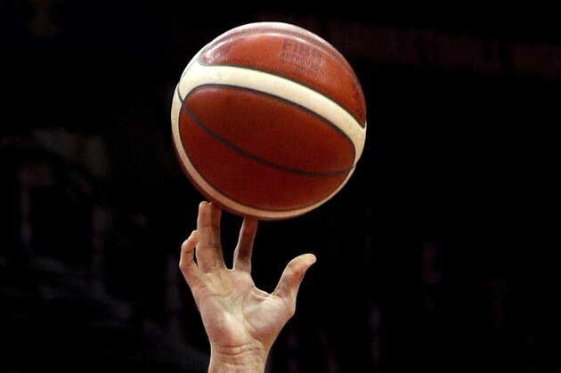 A close up view of tattoos on Argentina's Gabriel Deck's arm puts a shot over Grigory Motovilov of Russia during their Group B match in the FIBA Basketball World Cup, at the Wuhan Sport Center in Wuhan in central China's Hubei province, Wednesday, Sept. 4, 2019. (AP Photo/Andy Wong)