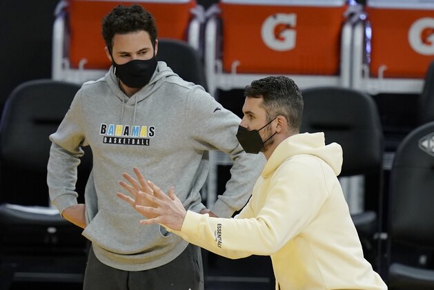 Golden State Warriors guard Klay Thompson, left, talks with Cleveland Cavaliers forward Kevin Love after the Warriors defeated the Cavaliers in an NBA basketball game in San Francisco, Monday, Feb. 15, 2021. (AP Photo/Jeff Chiu)