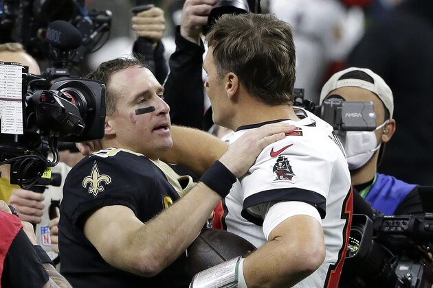 New Orleans Saints quarterback Drew Brees, center left, speaks with Tampa Bay Buccaneers quarterback Tom Brady after an NFL divisional round playoff football game, Sunday, Jan. 17, 2021, in New Orleans. The Buccaneers won 30-20. (AP Photo/Butch Dill)
