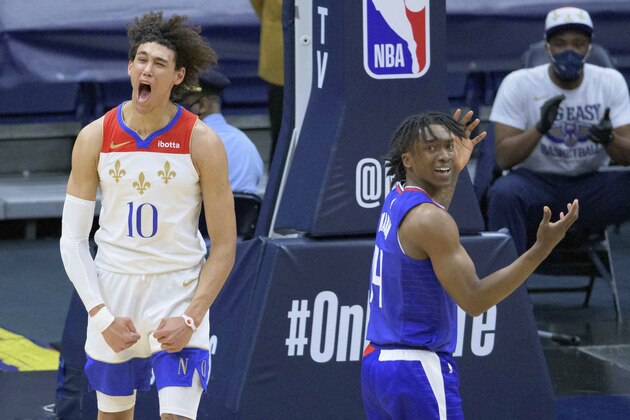 New Orleans Pelicans center Jaxson Hayes (10) celebrates a score and getting fouled by Los Angeles Clippers guard Terance Mann (14) in the first half of an NBA basketball game in New Orleans, Sunday, March 14, 2021. (AP Photo/Matthew Hinton)