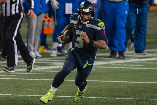 Seattle Seahawks quarterback Russell Wilson runs with the ball during the second half of an NFL wild-card playoff football game against the Los Angeles Rams, Saturday, Jan. 9, 2021, in Seattle. The Rams won 30-20. (AP Photo/Stephen Brashear)