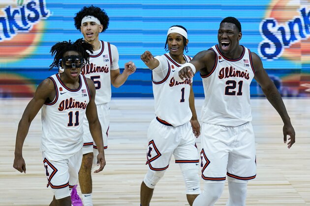 Illinois players Ayo Dosunmu (11), Andre Curbelo (5), Trent Frazier (1), and Kofi Cockburn (21) wave to fans in the closing minute of overtime in an NCAA college basketball championship game at the Big Ten Conference tournament, Sunday, March 14, 2021, in Indianapolis. Illinois defeated Ohio State  in overtime(AP Photo/Michael Conroy)