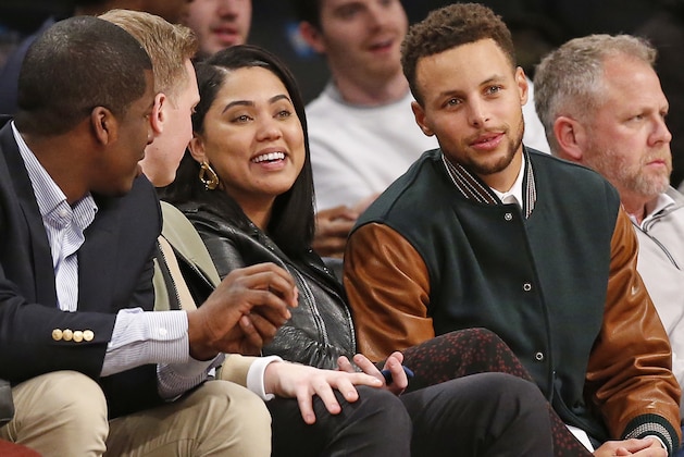 Golden State Warriors point guard Stephen Curry, second from right, sits with his wife Ayesha during the second half of an NCAA college basketball game between Penn State and Pittsburgh, Monday, Nov. 20, 2017, in New York. Curry was in town for a taping of The Tonight Show starring Jimmy Fallon. (AP Photo/Kathy Willens)