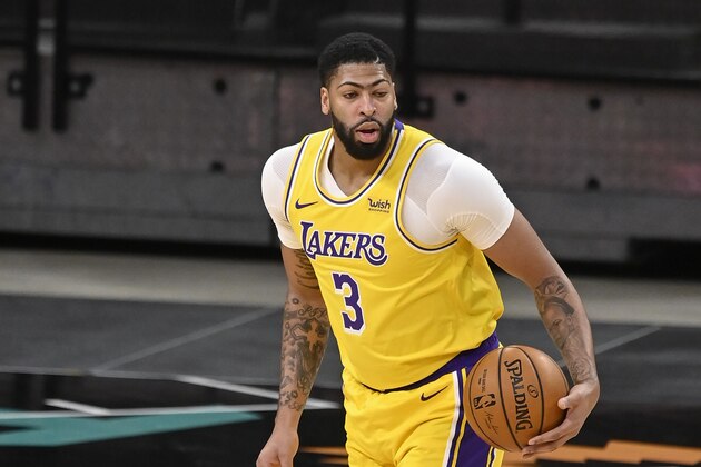 Los Angeles Lakers' Anthony Davis runs up the court during the first half of an NBA basketball game against the San Antonio Spurs, Friday, Jan. 1, 2021, in San Antonio. (AP Photo/Darren Abate)