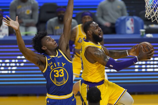 Los Angeles Lakers forward LeBron James, right, shoots against Golden State Warriors center James Wiseman (33) during the first half of an NBA basketball game in San Francisco, Monday, March 15, 2021. (AP Photo/Jeff Chiu)