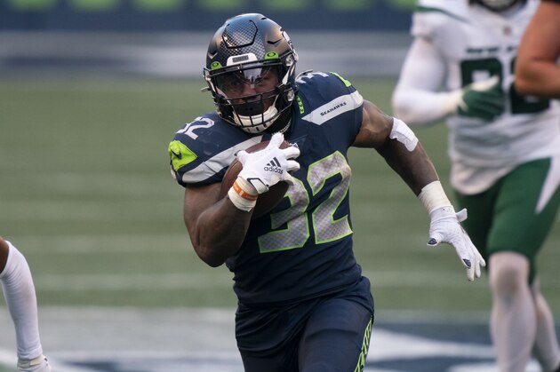 Seattle Seahawks running back Chris Carson runs with the during the second half of an NFL football game against the New York Jets, Sunday, Dec. 13, 2020, in Seattle. The Seahawks won 40-3. (AP Photo/Stephen Brashear)