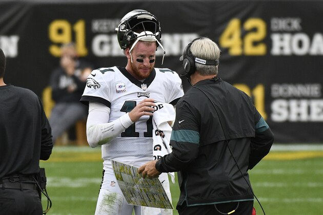 Philadelphia Eagles quarterback Carson Wentz (11) talks with head coach Doug Pederson during the second half of an NFL football game against the Pittsburgh Steelers in Pittsburgh, Sunday, Oct. 11, 2020. (AP Photo/Don Wright)