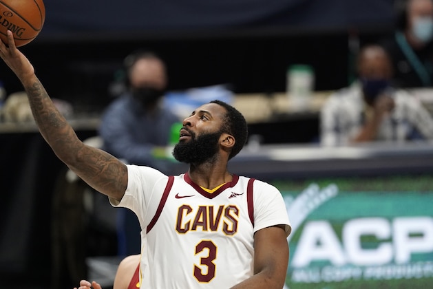 Cleveland Cavaliers center Andre Drummond, front, drives to the rim past Denver Nuggets center Nikola Jokic in the second half of an NBA basketball game Wednesday, Feb. 10, 2021, in Denver. (AP Photo/David Zalubowski)