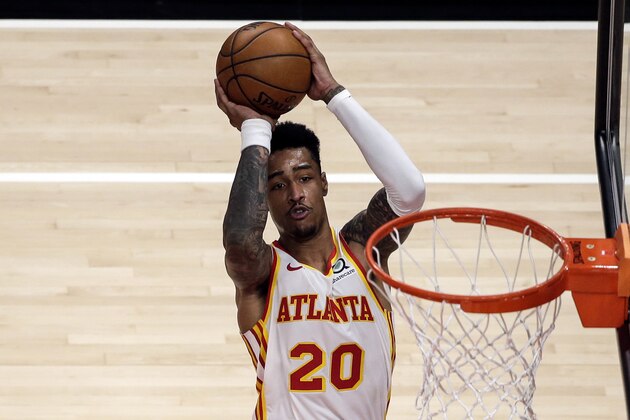 Atlanta Hawks forward John Collins (20) puts up a shot against the Indiana Pacers during the third quarter of an NBA basketball game Saturday, Feb. 13, 2021, in Atlanta. (AP Photo/Butch Dill)