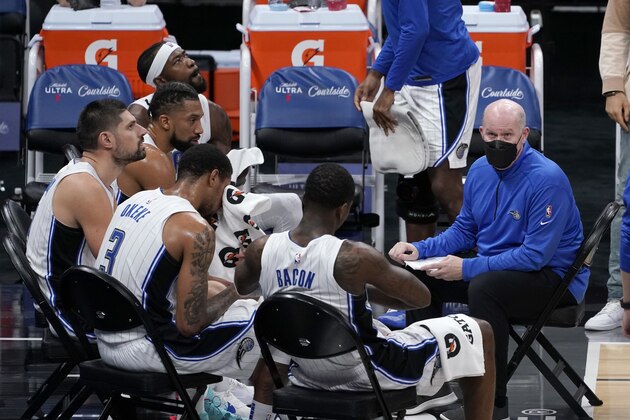 Orlando Magic coach Steve Clifford, right, huddles with the team during a timeout in the second half of an NBA basketball game against the Sacramento Kings in Sacramento, Calif., Friday, Feb. 12, 2021. The Magic won 123-112. (AP Photo/Rich Pedroncelli)